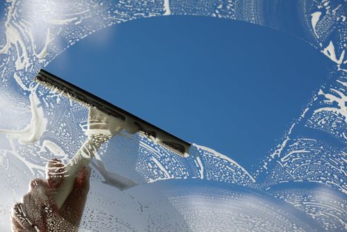 soap suds covering window on a clear blue sky