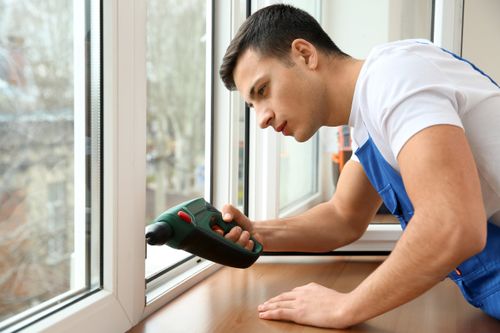 worker ensuring the seals of windows to prevent fogging
