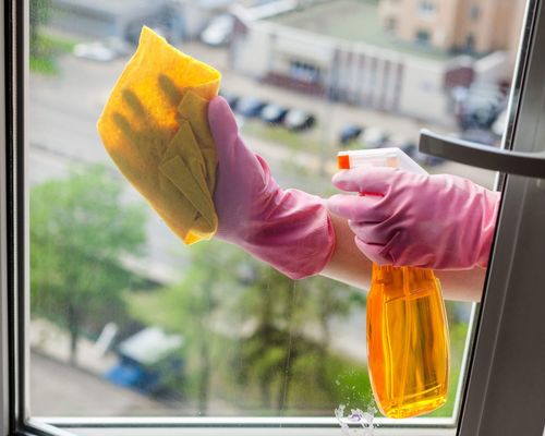 worker cleaning foggy window